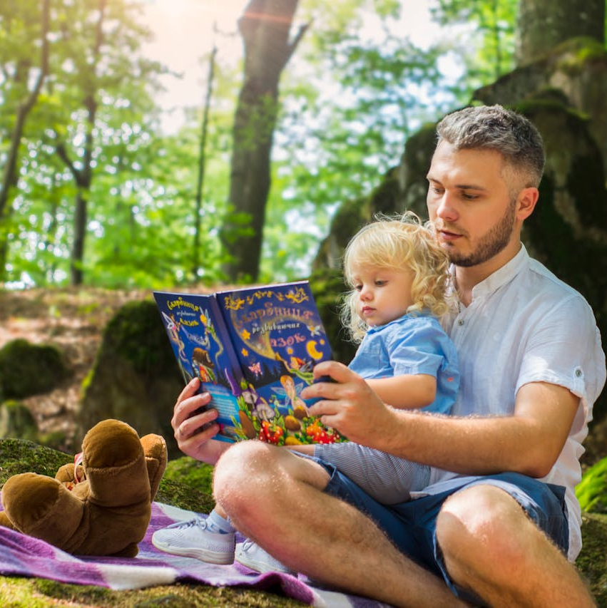 A cozy corner filled with beautifully illustrated children’s books featuring animals, forests, and balloons. Fairy lights, crayons, confetti, and a plush bunny create a warm, magical storytime atmosphere.