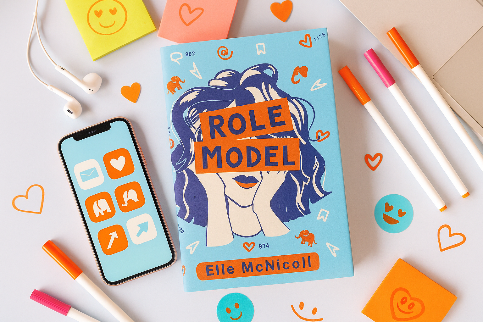 Book titled 'Role Model' by Elite McNicoll with a phone, markers, and colorful heart-shaped stickers on a light background.